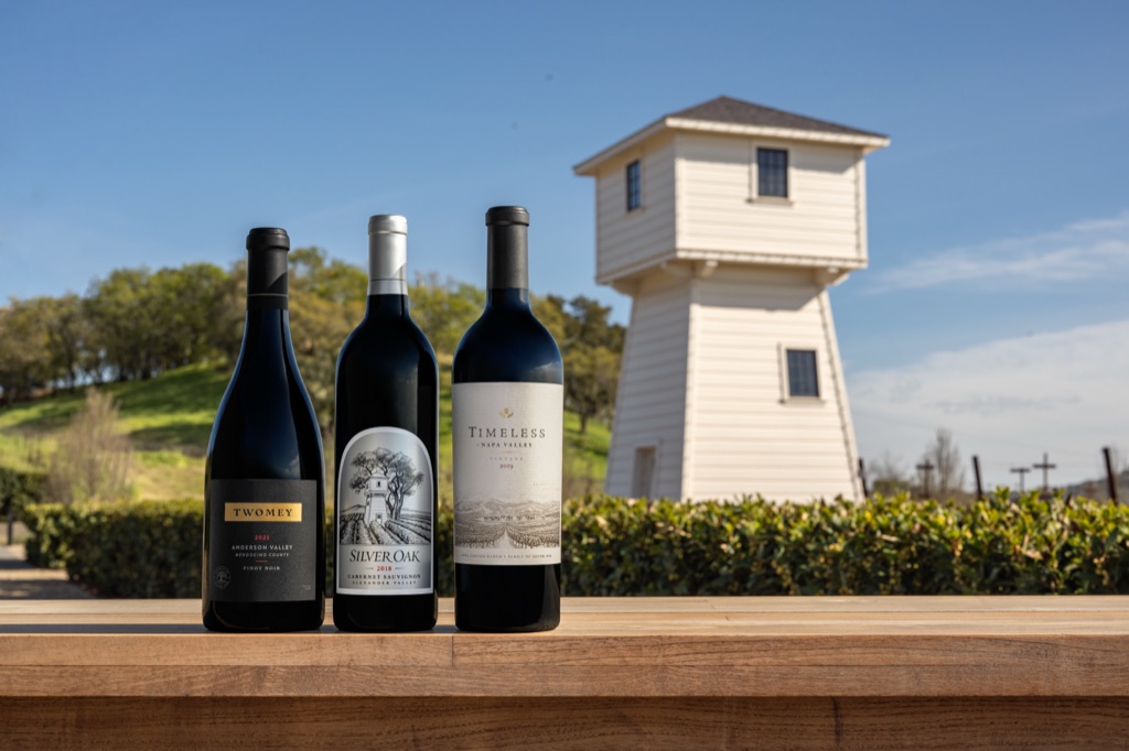 Silver Oak, Twomey and Timeless bottles lined up before the white water tower at Silver Oak's Alexander Valley winery, photographed by Dawn Heumann