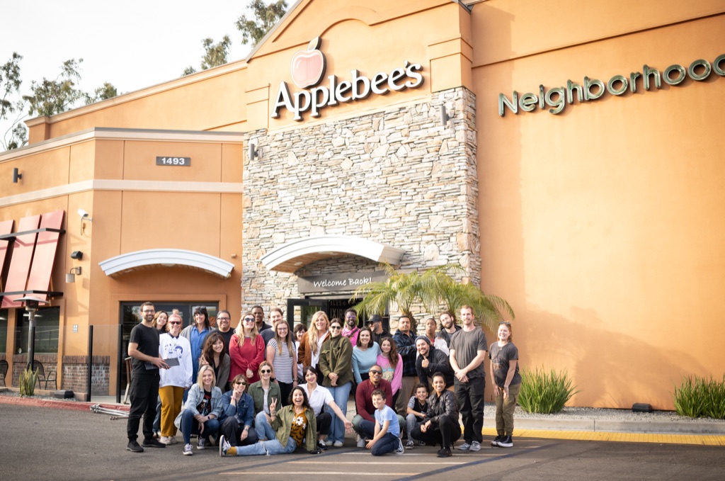 Cast and crew gathered outside Applebee's after a campaign shoot day