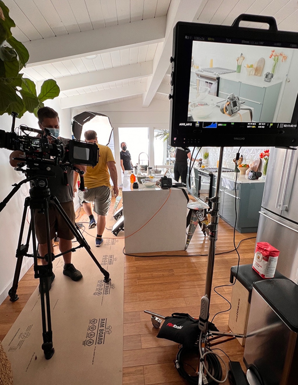 Cinema camera and monitor framing a bright kitchen scene on a motion shoot
