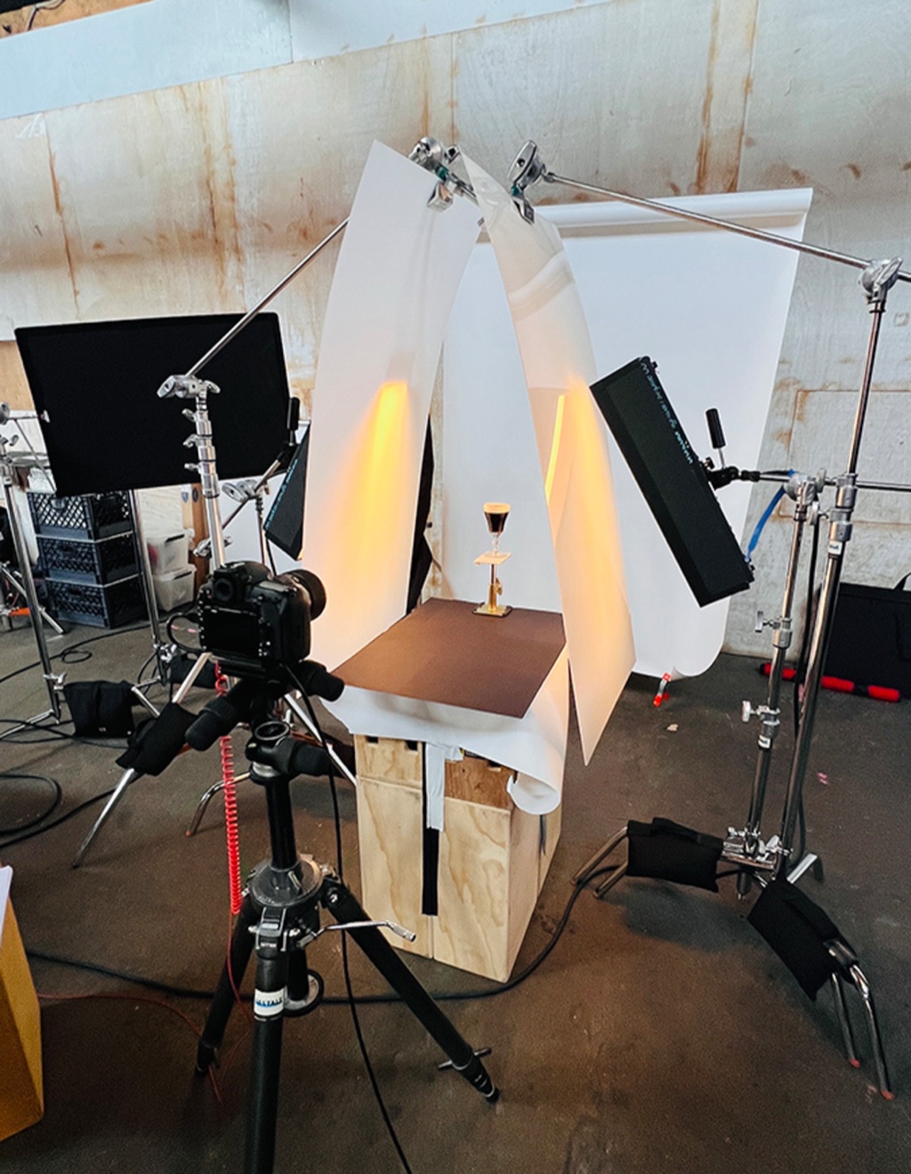 A precision product lighting build with curved paper bounces wrapped around one small product