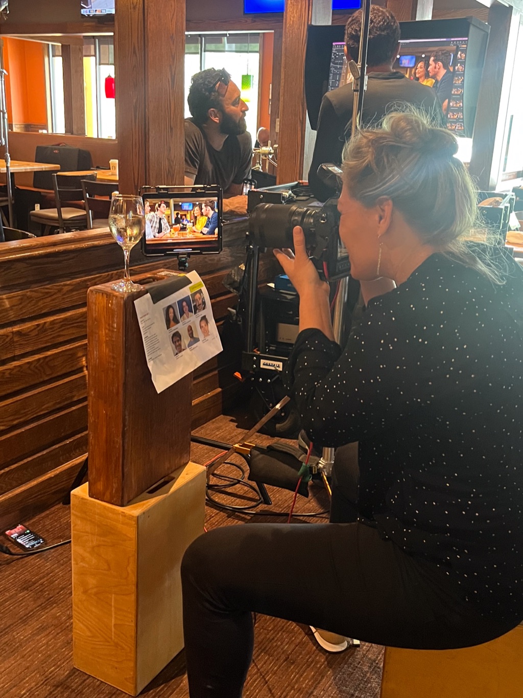 Shot list taped beside the director's monitor as Dawn Heumann lines up a restaurant scene