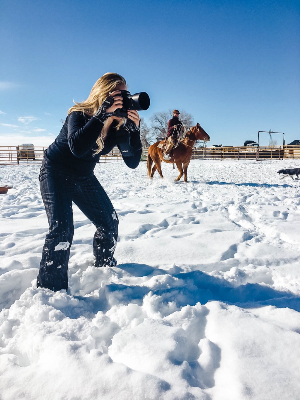 Dawn Heumann shooting a horse and rider in deep snow on a winter ranch production