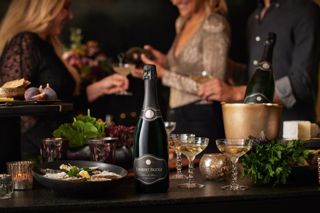 Lambert Bridge blanc de blancs with vintage coupes and a bowl of oysters at an evening gathering