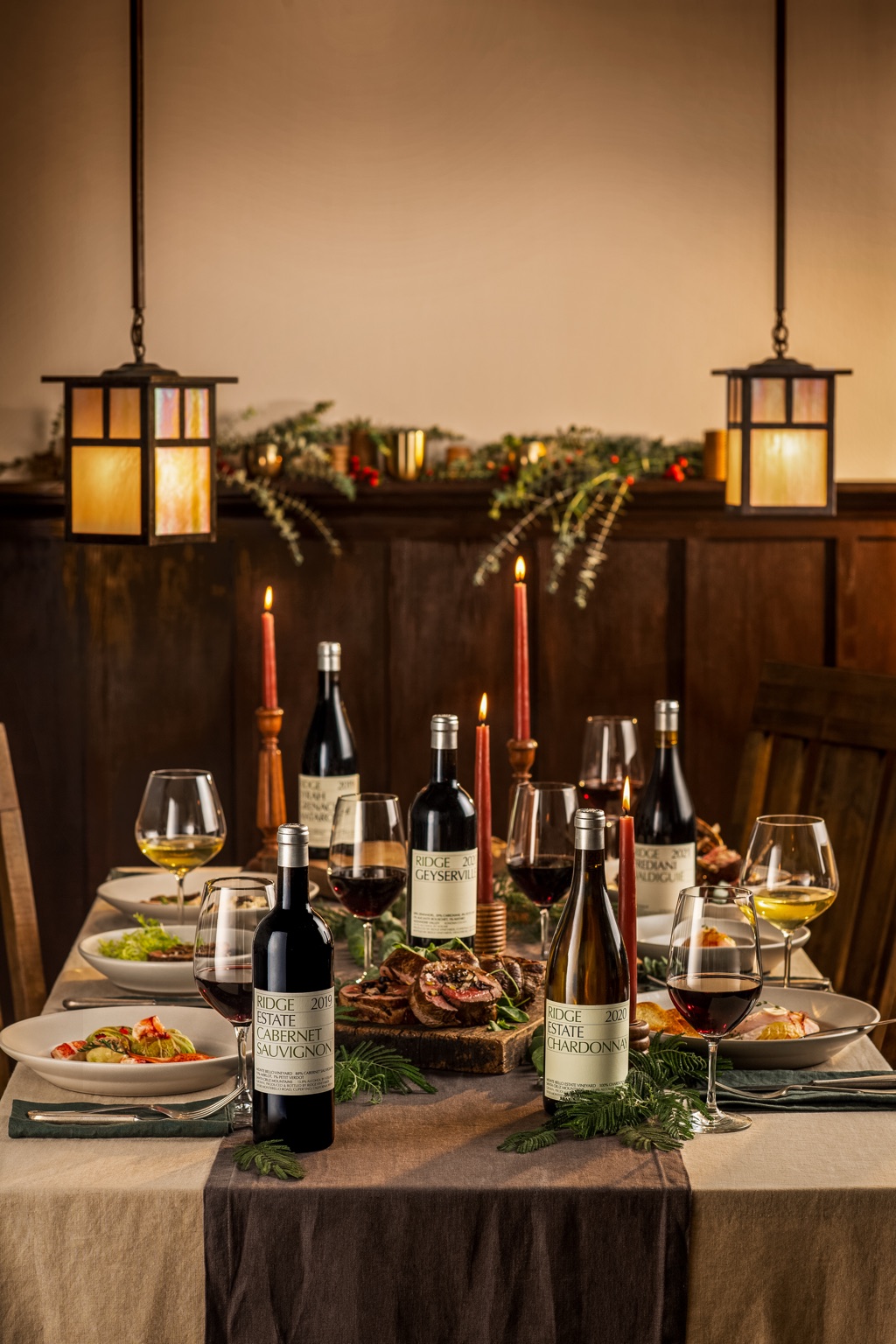 Ridge Vineyards estate cabernet, Geyserville and chardonnay on a candlelit holiday table under craftsman lanterns