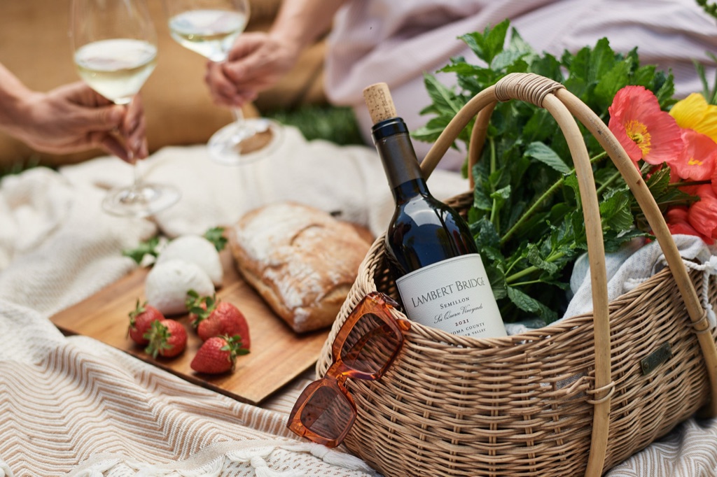 Lambert Bridge semillon tucked into a wicker picnic basket with poppies, strawberries and fresh bread