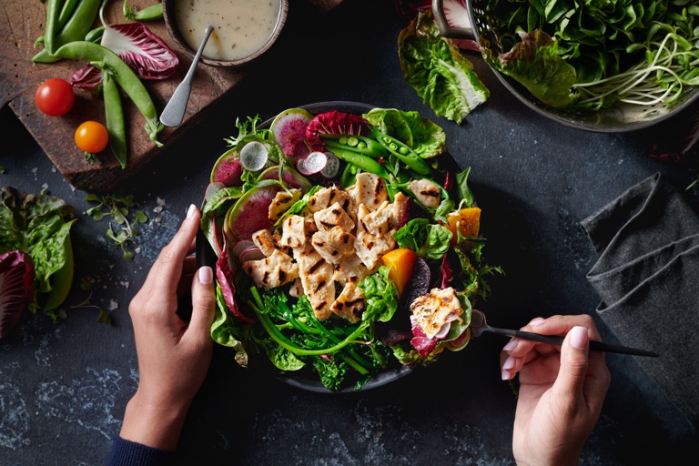 Hands serving a fresh chicken salad, food photography by Dawn Heumann