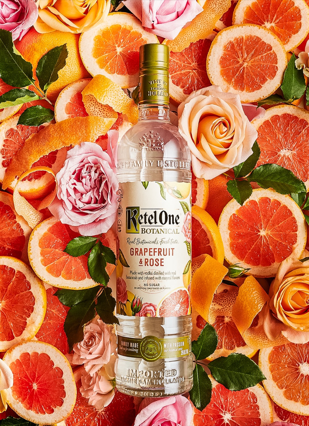 Ketel One Botanical grapefruit and rose bottle on a bed of grapefruit slices and garden roses