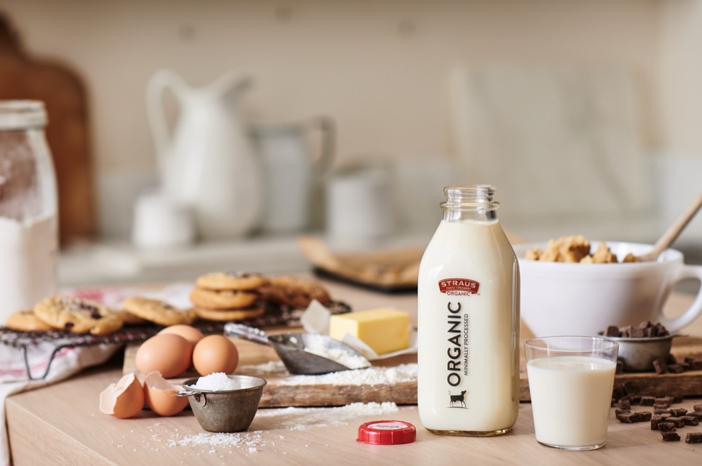 Straus Family Creamery organic milk bottle beside fresh-baked chocolate chip cookies