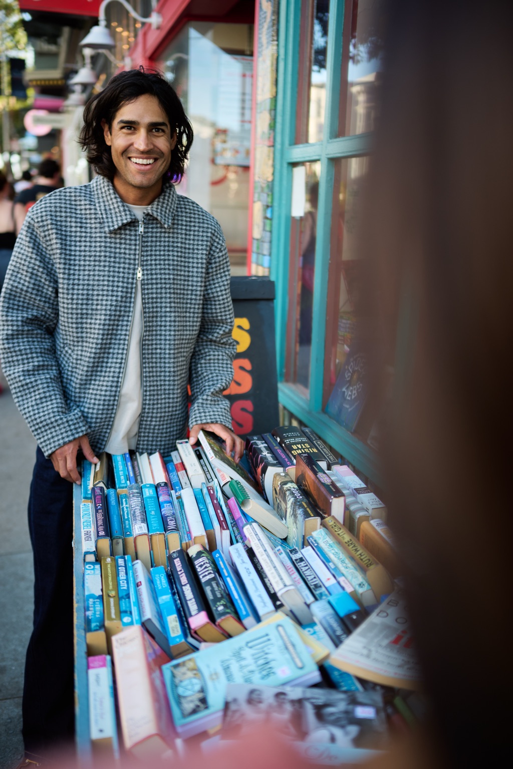 Man laughing at a sidewalk bookstore stand in San Francisco