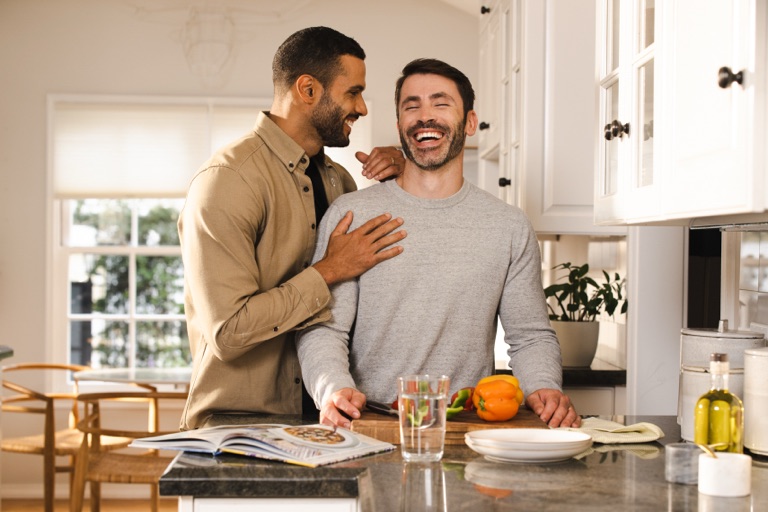 Friends cooking together in a bright kitchen