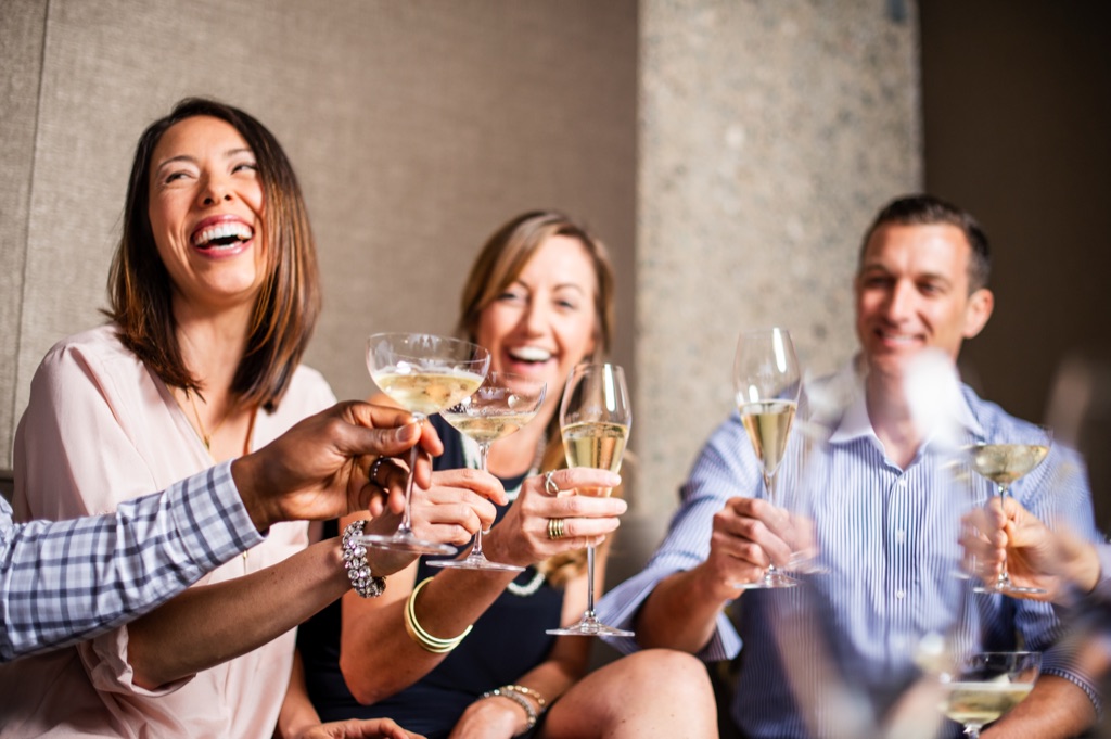 Three friends toasting with sparkling wine in an elegant lounge