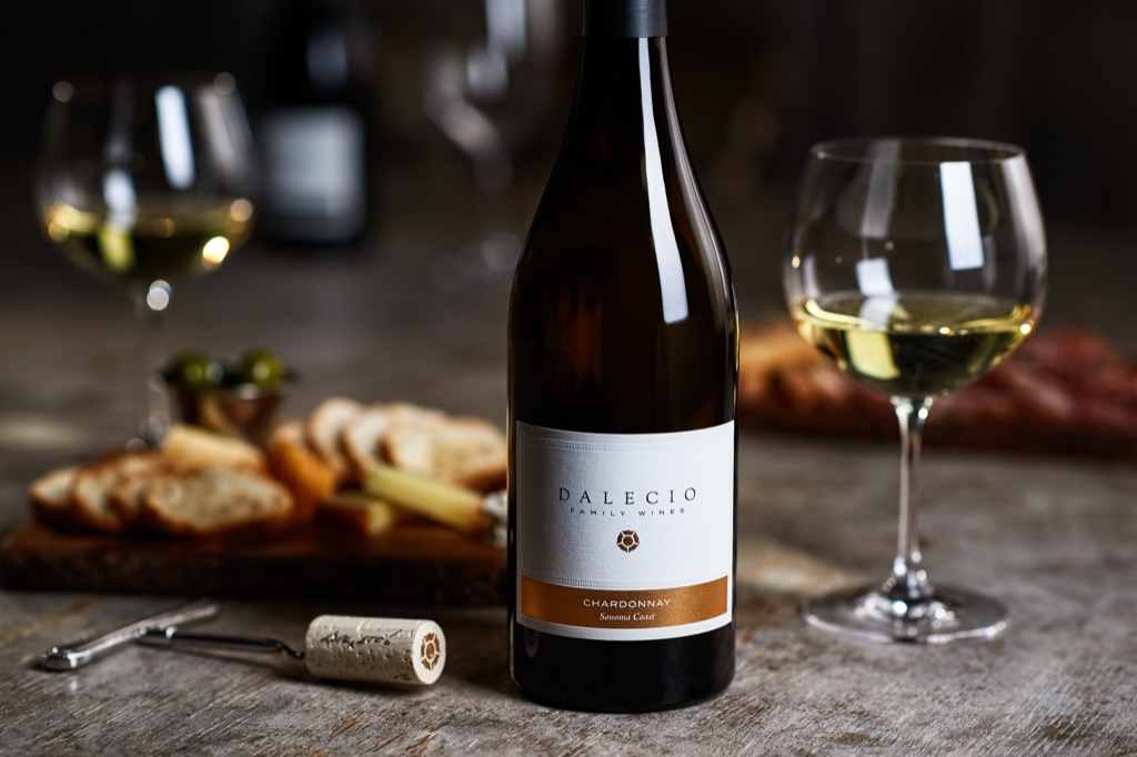 Dalecio Family Wines chardonnay with burgundy glasses and a crostini board in soft window light