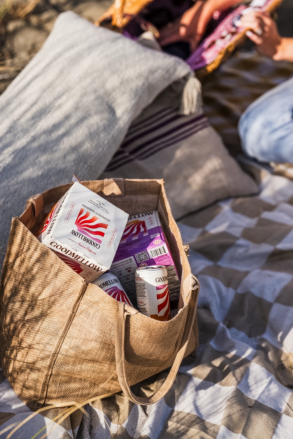 Goodmellow drinks packed in a jute tote at the beach