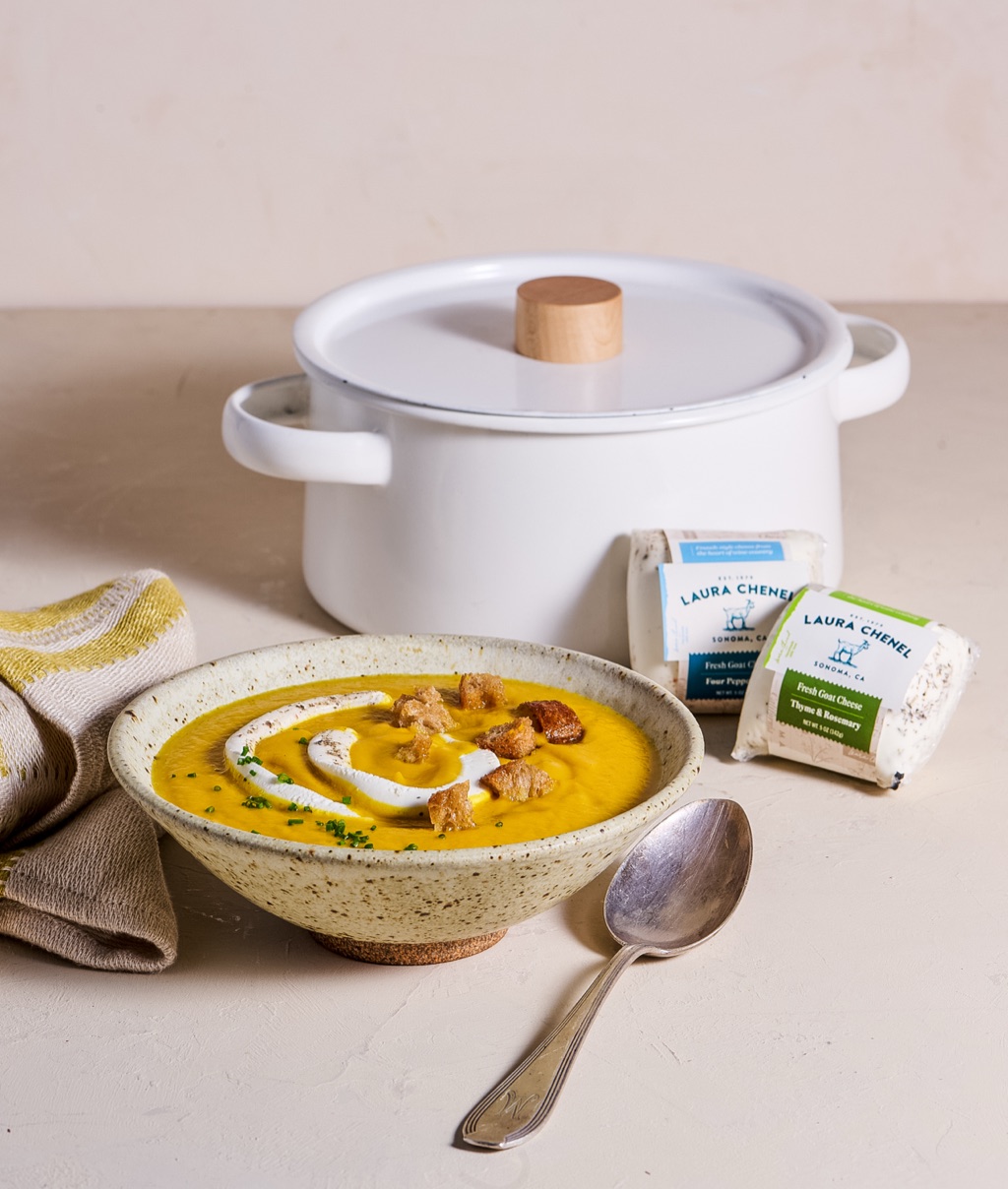 Laura Chenel goat cheese beside a bowl of butternut squash soup
