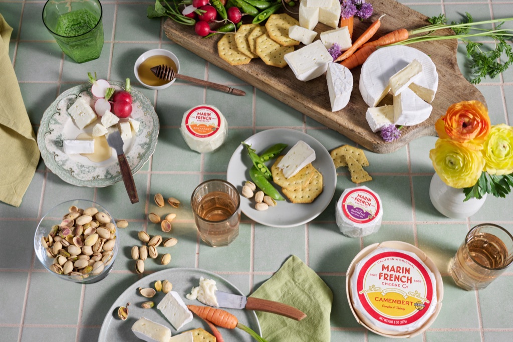 Overhead picnic spread with Marin French Cheese wheels