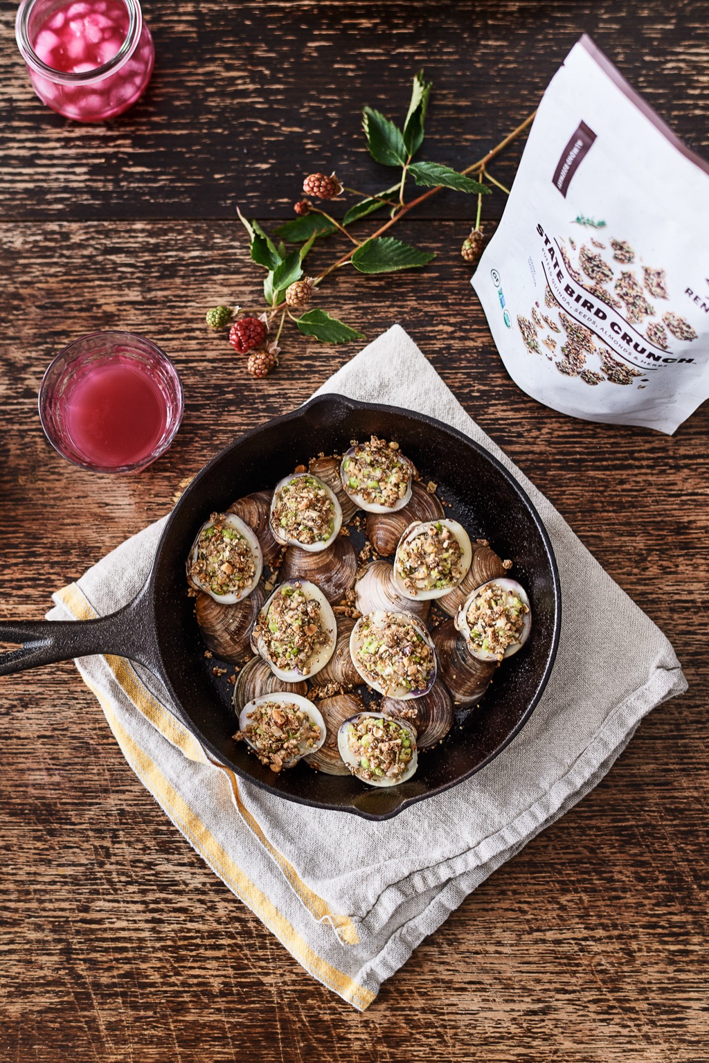 Overhead of baked clams topped with State Bird Crunch
