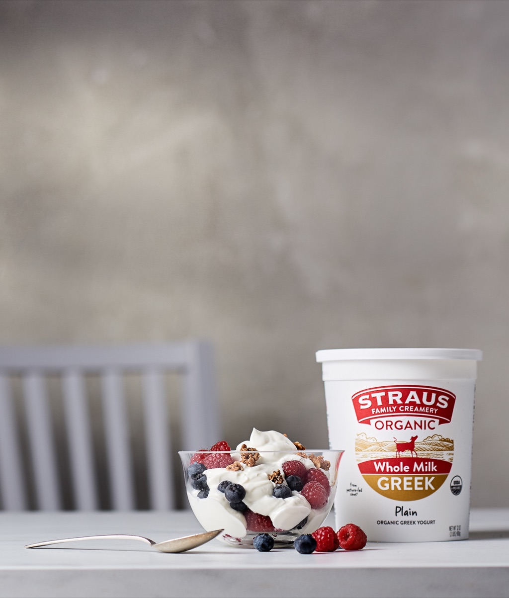 Straus whole milk Greek yogurt with a bowl of fresh berries
