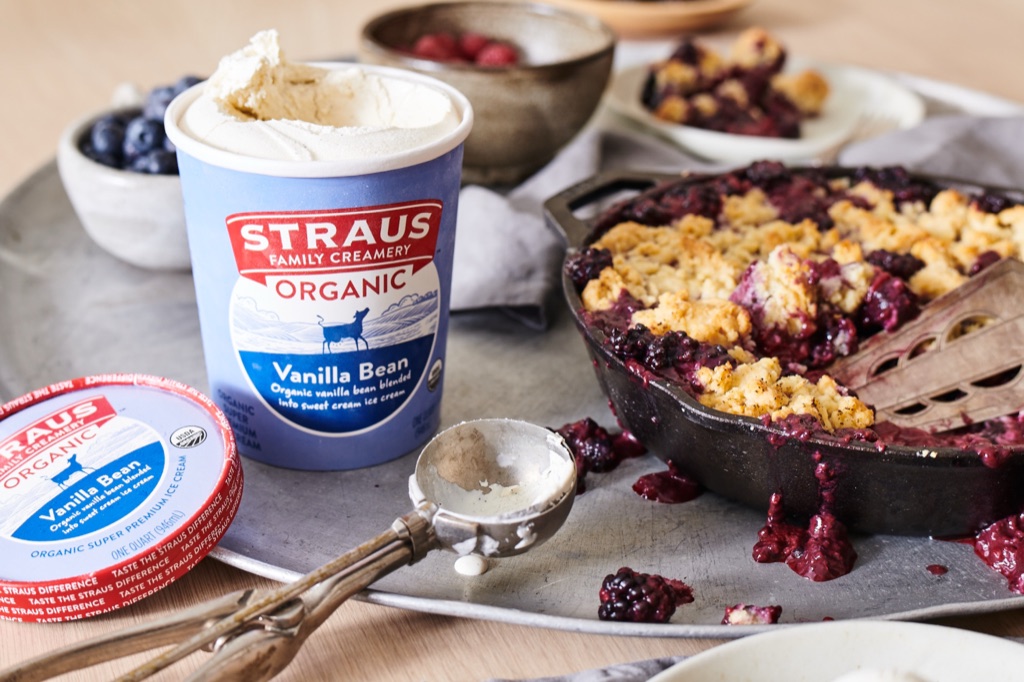 Straus Vanilla Bean ice cream beside a skillet blackberry cobbler