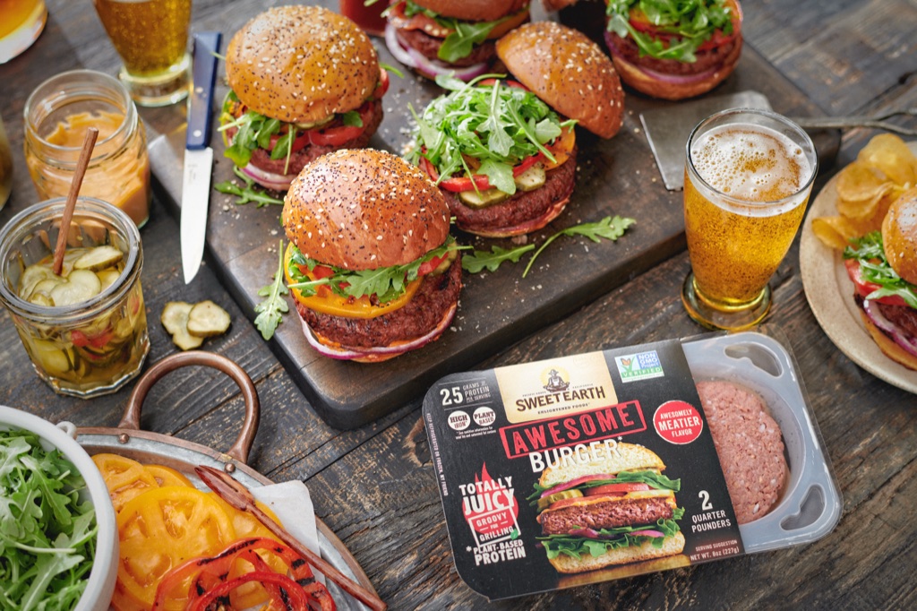 Sweet Earth Awesome Burger package with a board of finished burgers