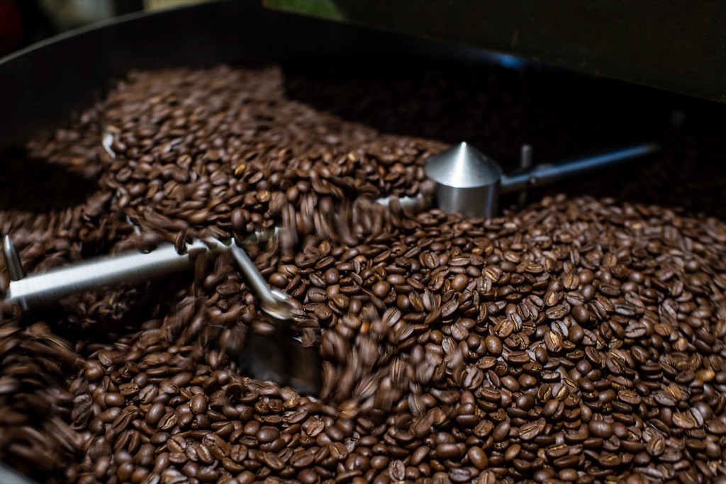 Freshly roasted coffee beans swirling in the roaster cooling tray