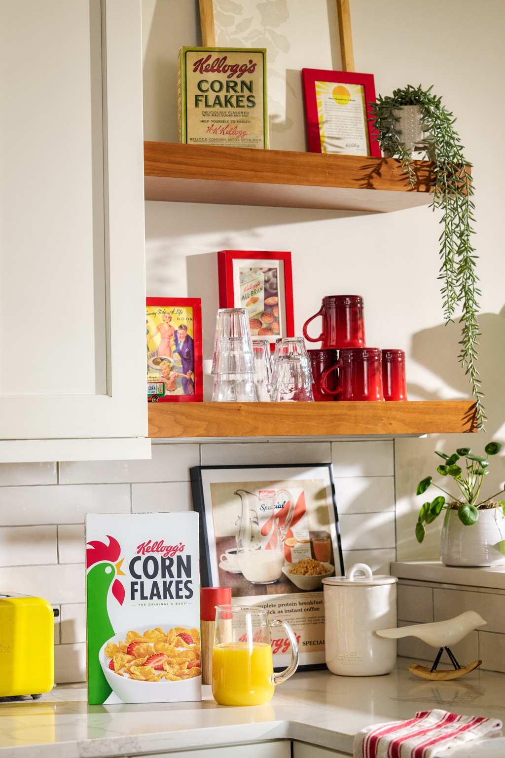 Kitchen shelf styled with vintage Kellogg's Corn Flakes memorabilia and the modern box, set design photographed by Dawn Heumann