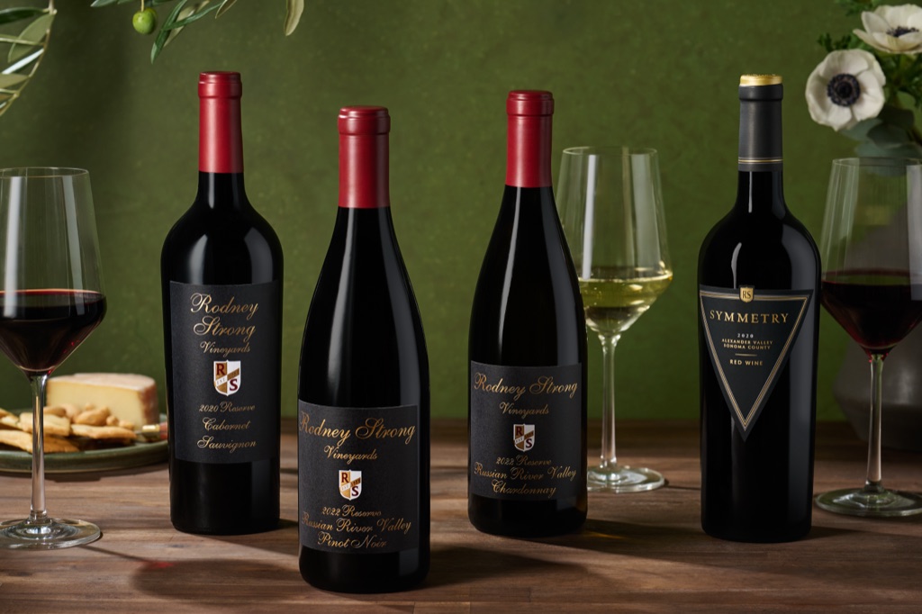 Rodney Strong Reserve wines and Symmetry red blend on a deep green backdrop with olive branches and cheese