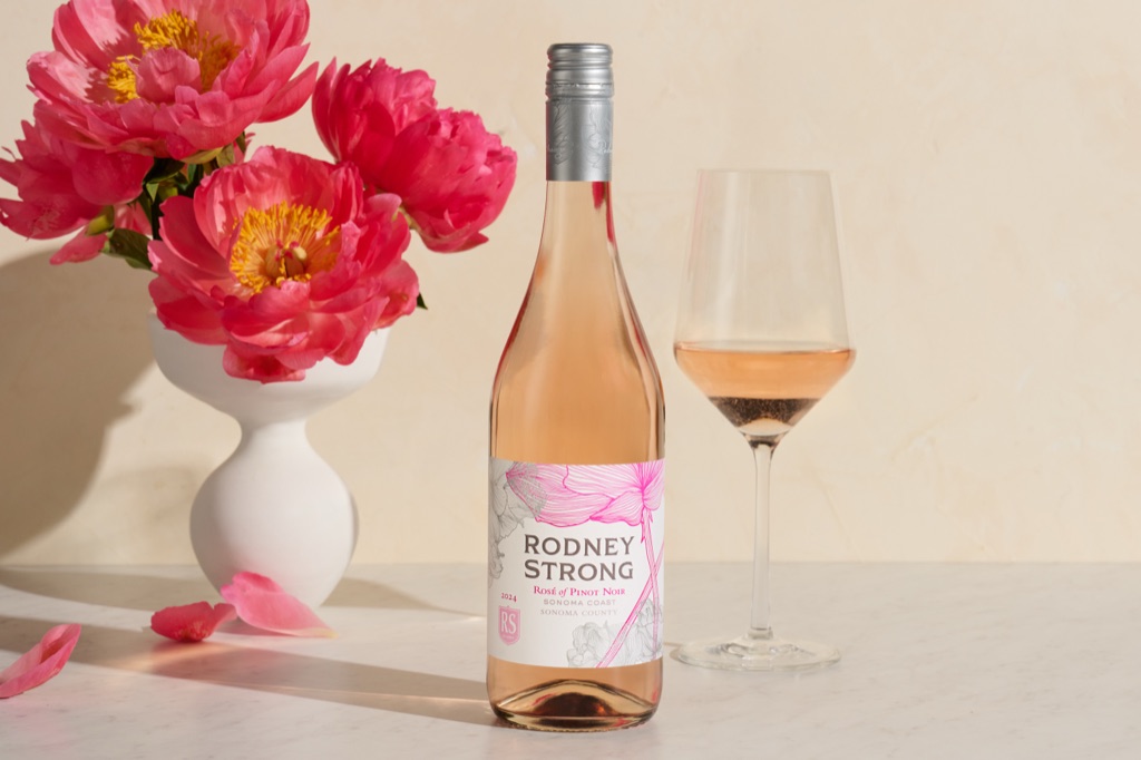 Rodney Strong Rose of Pinot Noir from the Sonoma Coast with a glass and bright pink peonies