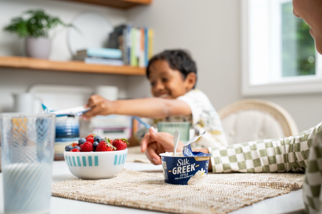Silk Greek Style coconutmilk yogurt at the breakfast table with fresh berries