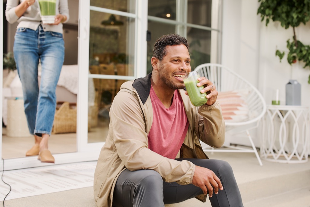 Dad enjoying a green smoothie on the patio step, Silk campaign photography by Dawn Heumann