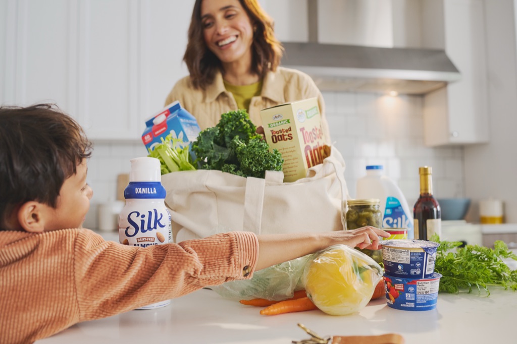Unpacking groceries with Silk creamer and yogurt on the counter, campaign photography by Dawn Heumann