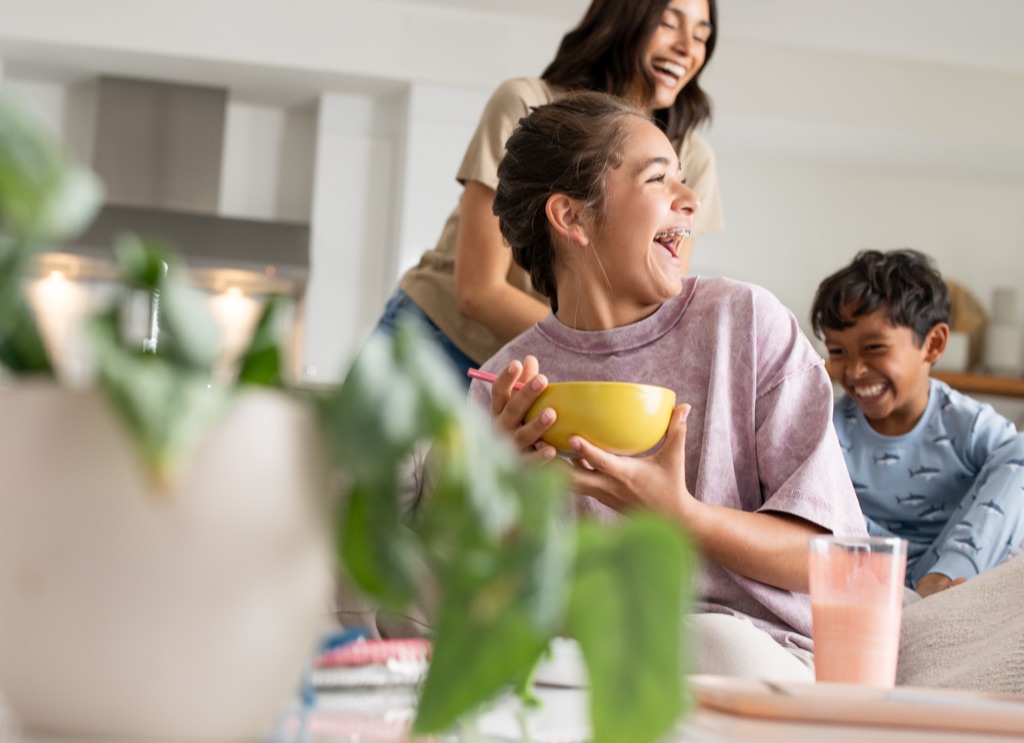 Three kids cracking up over breakfast bowls, Silk campaign photography by Dawn Heumann