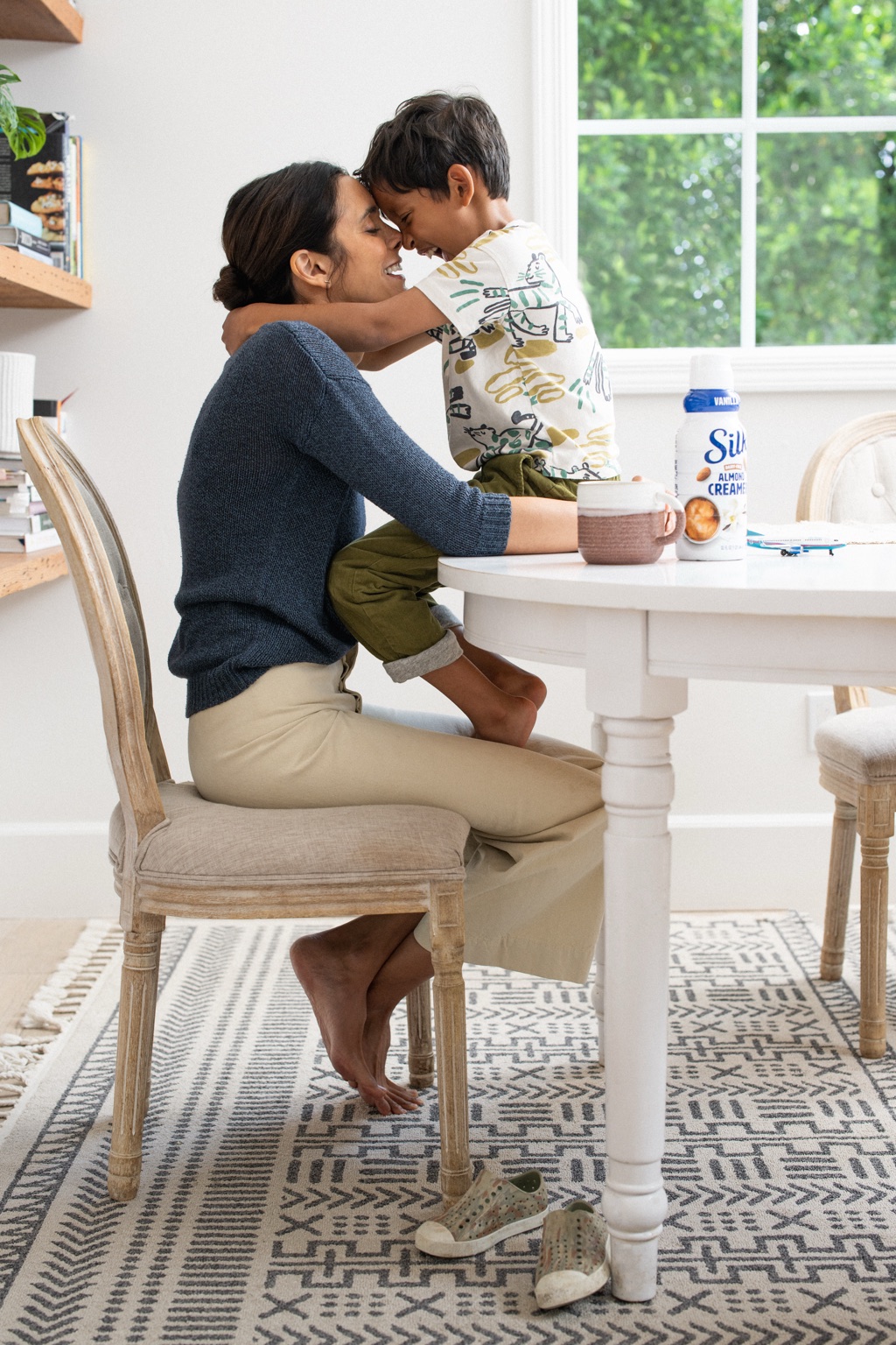 Mom and son nose to nose at the breakfast table with Silk almond creamer