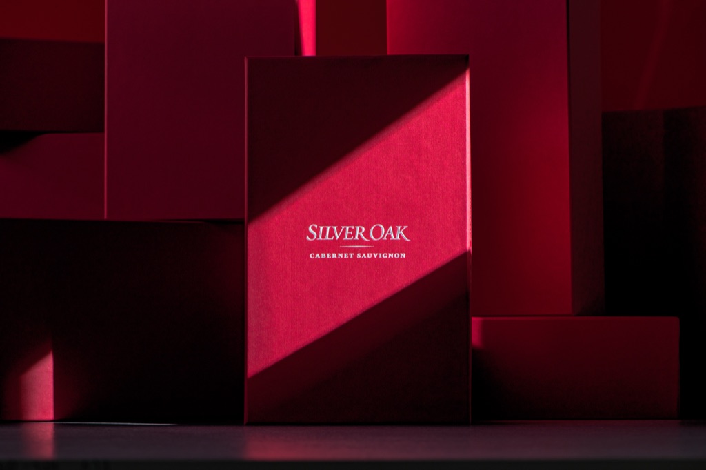 Red Silver Oak Cabernet Sauvignon gift box lit by a diagonal shaft of light in a sea of red boxes