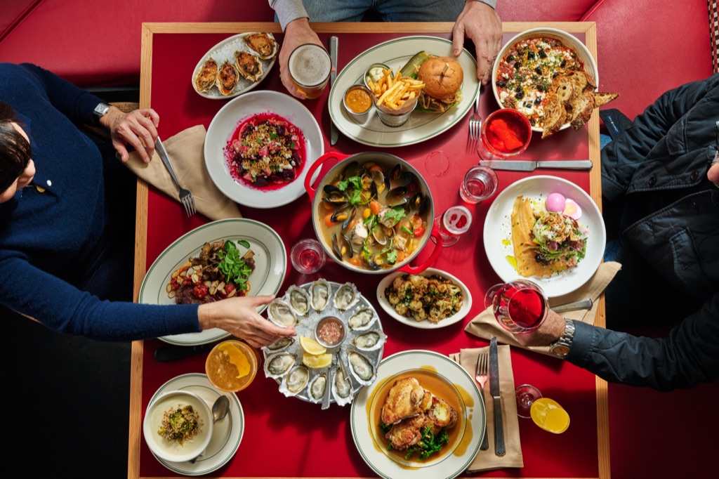 Overhead of a brasserie table set with red accents