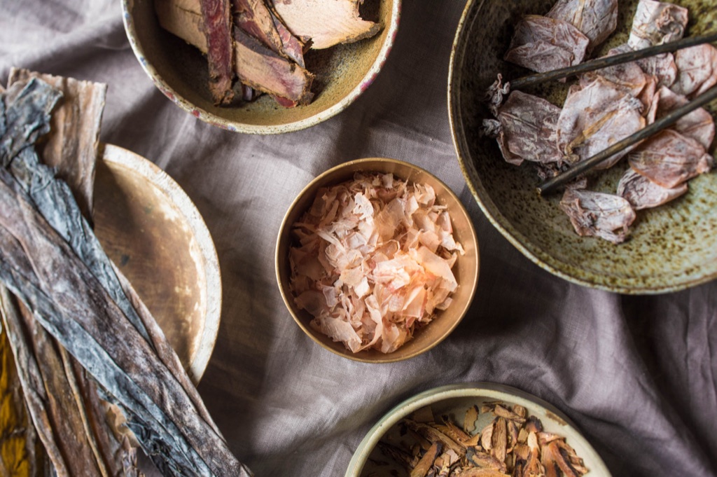 Overhead of dashi ingredients laid out on a chef's prep counter