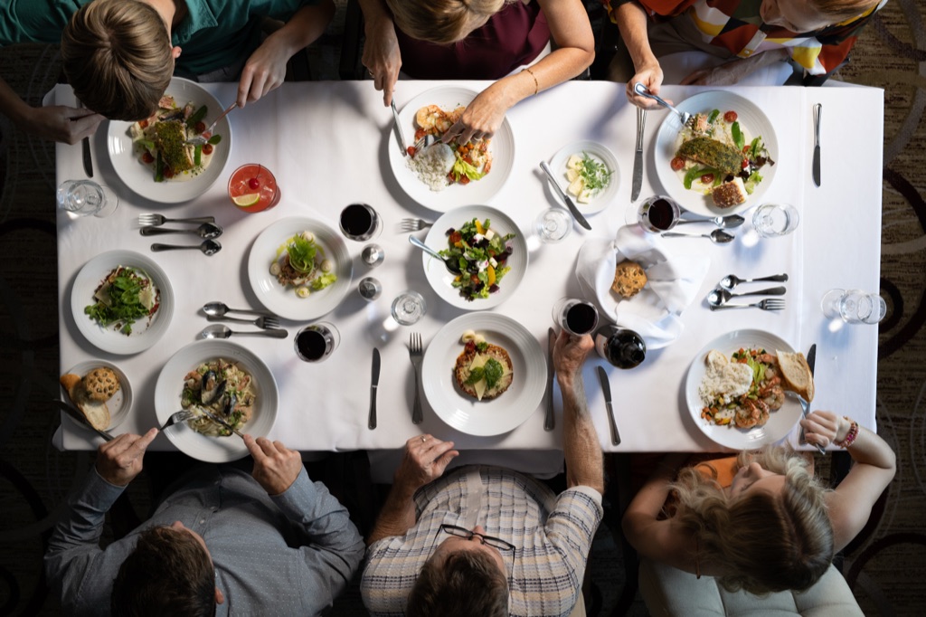 Overhead of a full dinner table mid-meal