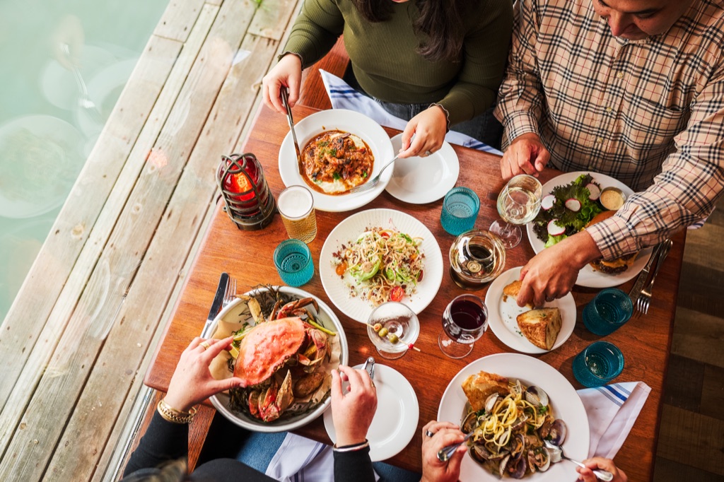 Overhead of a Dungeness crab feast on a wharf-side table