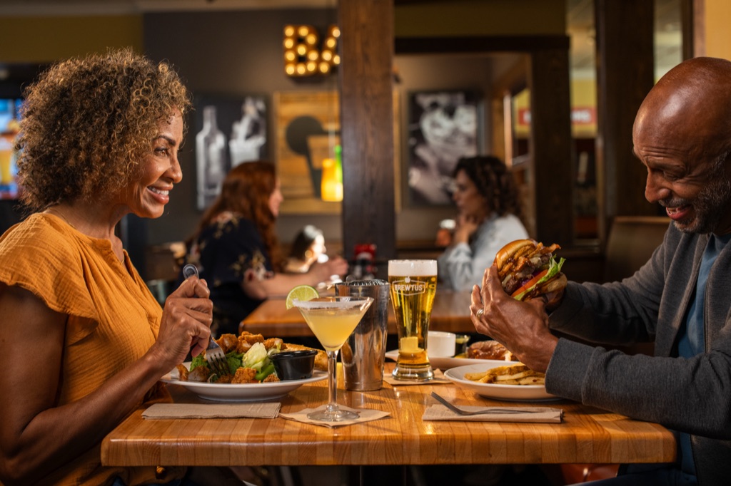 Date night burger and beer at a pub table