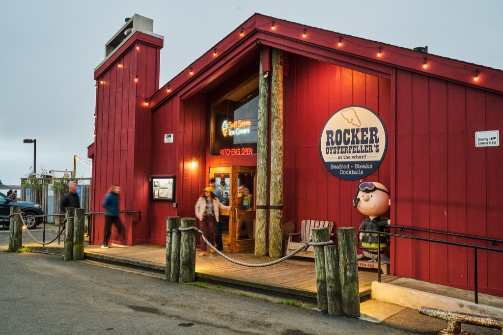 Warm light spilling from Rocker Oysterfeller's at dusk, photographed by Dawn Heumann