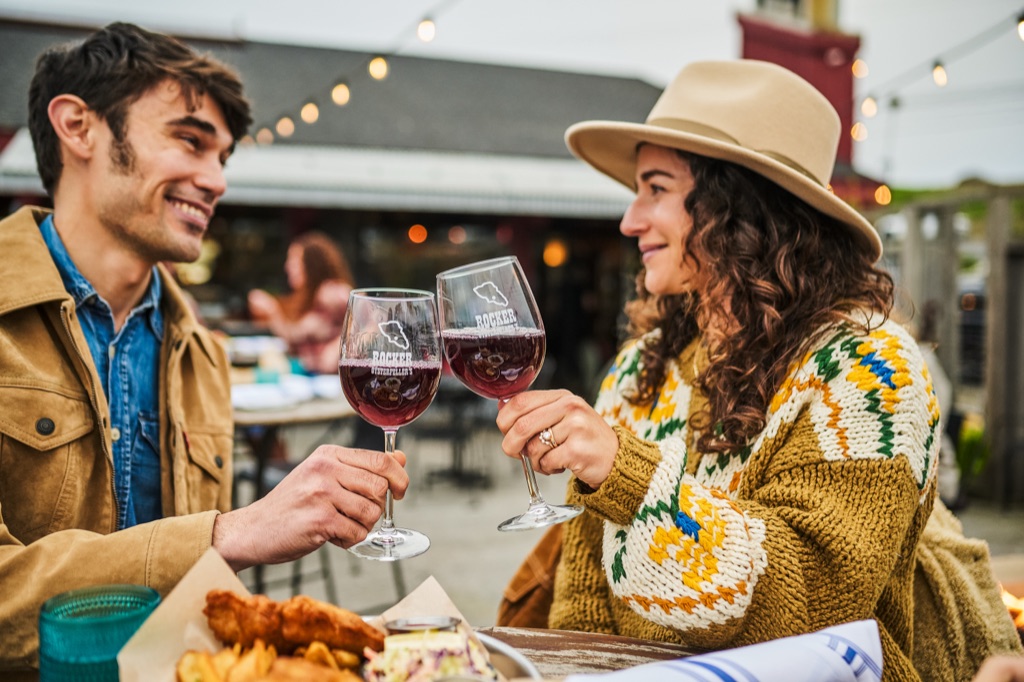 Friends toasting on the patio at Rocker Oysterfeller's