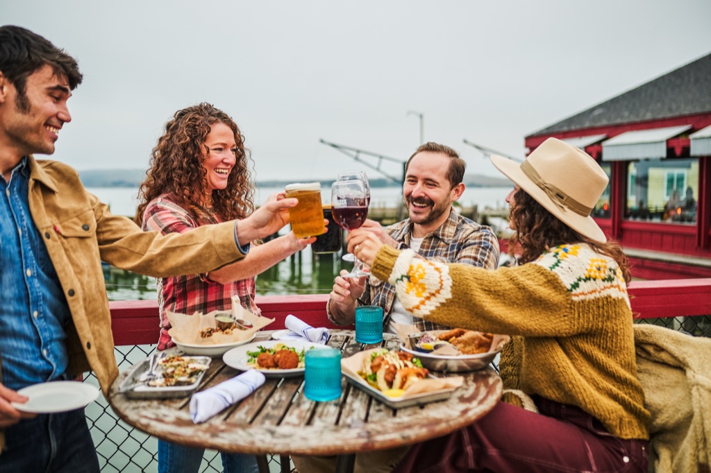 Friends raising a toast on a wharf patio