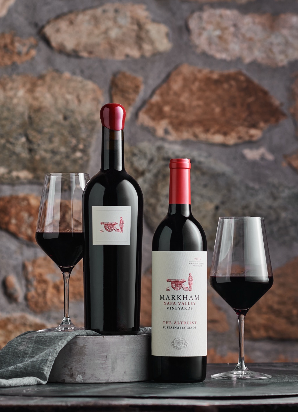 Markham Napa Valley The Altruist bottle and wax topped magnum against a stone wall