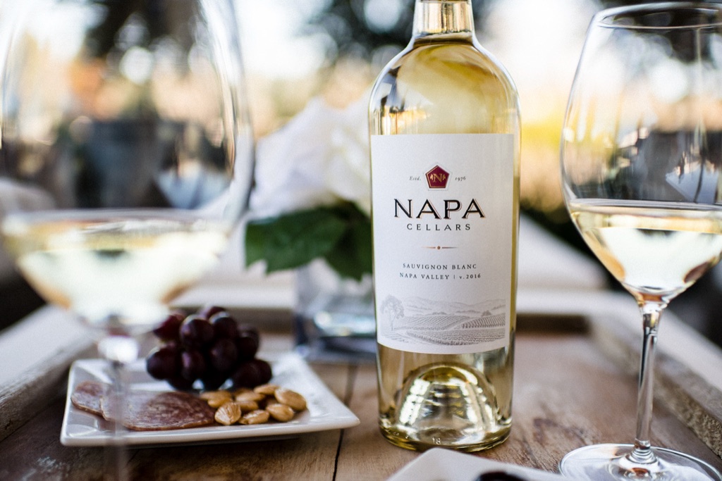 Napa Cellars sauvignon blanc on an outdoor table with charcuterie and grapes