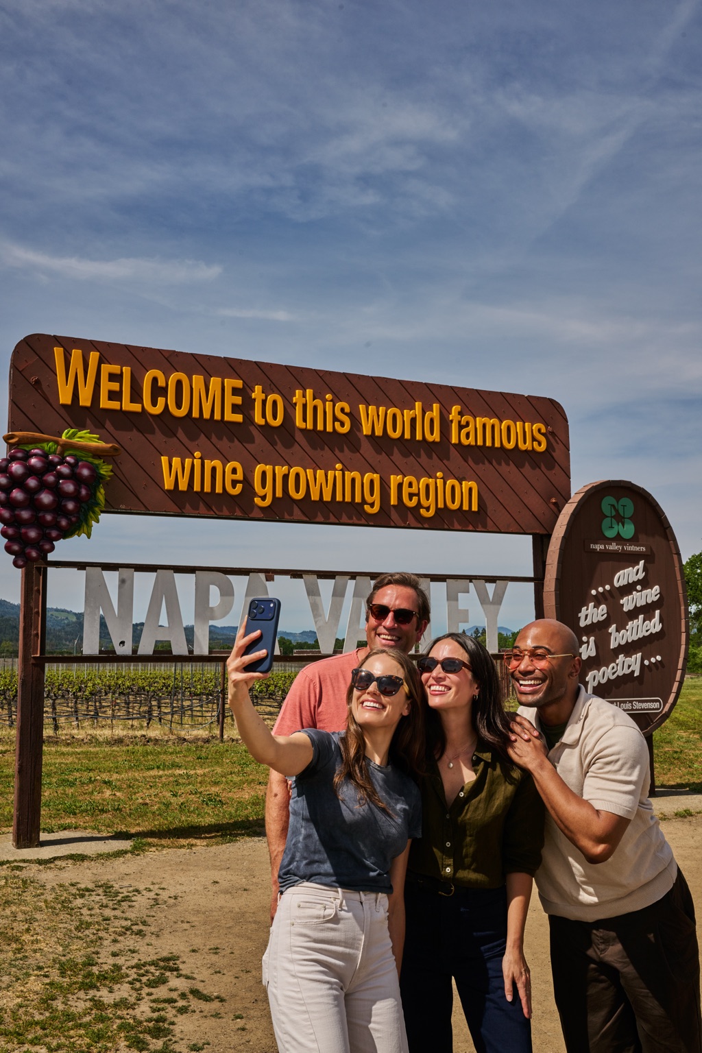 Four friends taking a selfie at the Napa Valley welcome sign