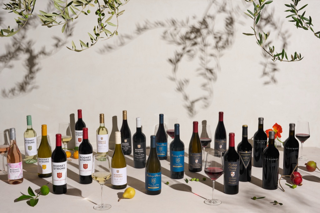 Rodney Strong Vineyards portfolio of bottles under olive branches and afternoon shadows